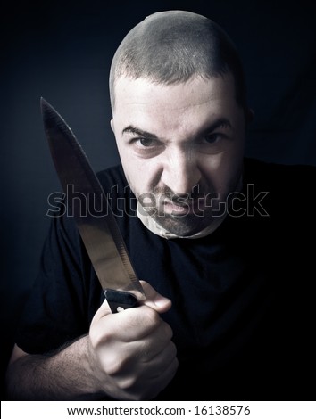 Ugly criminal with stockings over face and knife in his hand