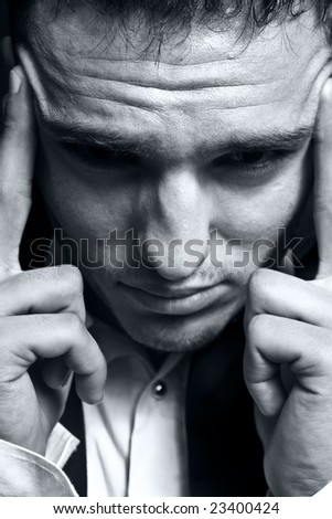Closeup portrait of stressed businessman with headache