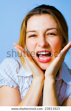 Portrait of excited funny woman making a big scream