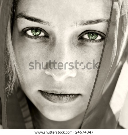 Artistic portrait of mysterious woman with beautiful eyes