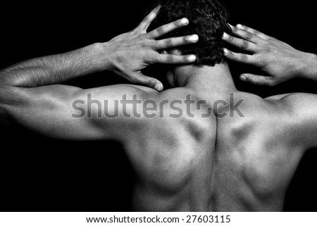 Back of muscular athletic young man over black