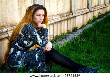 Solitude concept - sad pensive woman sitting alone
