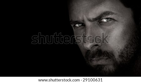 Low-key portrait of scary man with evil eyes