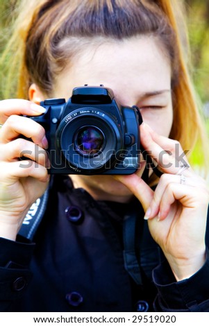 Female photographer with digital photo camera in hands