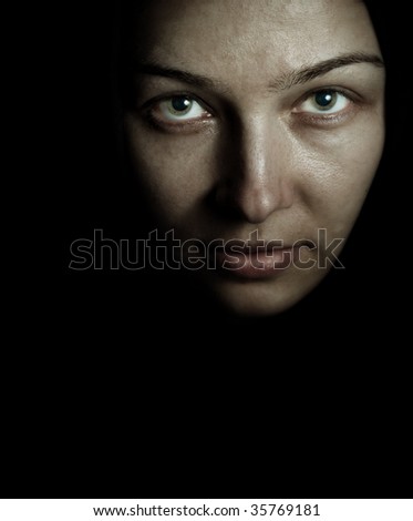 Face of spooky mystery woman in the dark