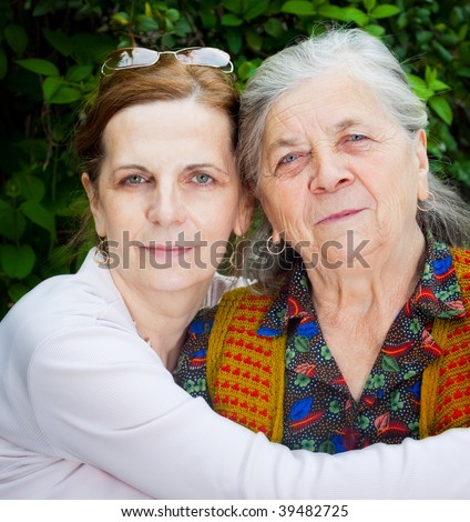 Family portrait - middle age daughter and senior mother