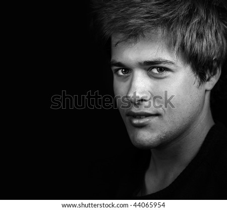 Dark portrait of one handsome confident young man