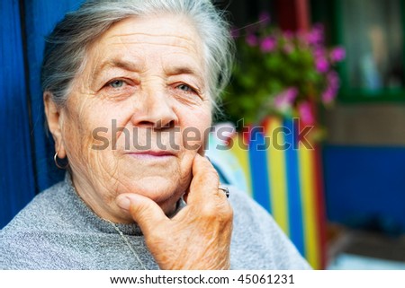 Portrait of one content old senior lady