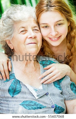 Happy family portrait - daughter and grandmother outdoor