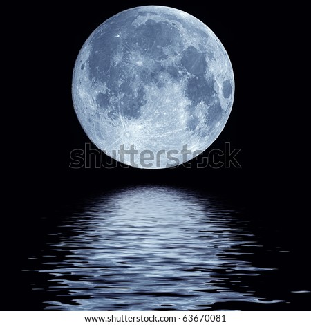 Full blue moon over cold night water - stock photo