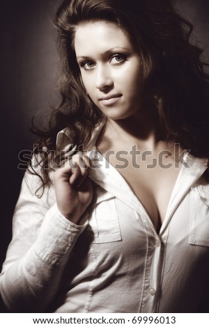 Studio portrait of sexy busty young brunette woman