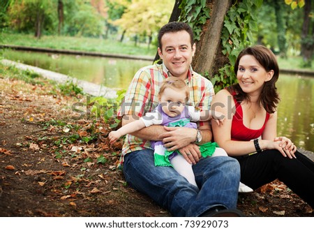 Family portrait - mother father and baby daughter outdoor