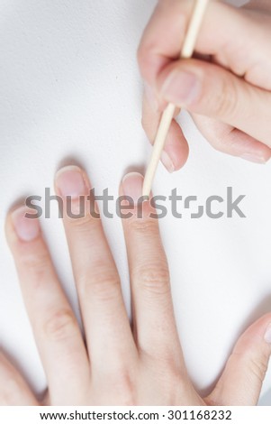 Closeup of Woman applying nail varnish to finger nails