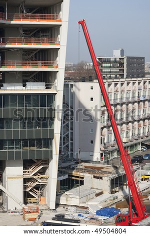 Telescopic crane at a urban construction site