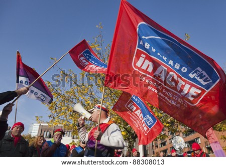 UTRECHT, THE NETHERLANDS  - NOVEMBER 1: Unidentified member of the Dutch civil servants trade union (AbvaKabo) waves a flag during a protest on November 1, 2011 in Utrecht, The Netherlands.
