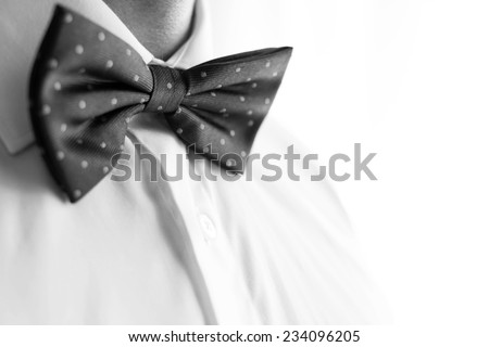 Fashionable groom wearing a bowtie on his wedding day. B&w photo