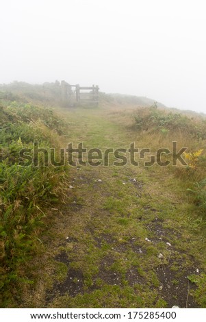 Footpath in the mist. Abbotsbury Castle, Dorset, England, United Kingdom.