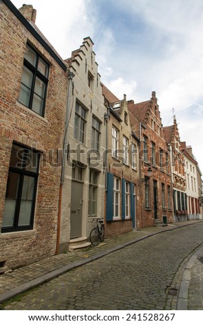 Typical, charming street with bicycle by door. Bruges, West Flanders, Belgium, Europe.