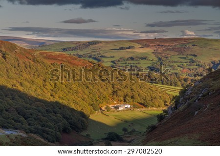 Looking down from Hill at valley farm, last few minutes of sunlight, evening, autumn, fall. Near Elan Valley, Powys, Wales, United Kingdom, Europe.