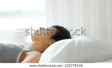 Close up of woman sleeping in bed in the morning, profile shot