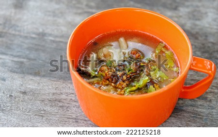 Rice soup with minced pork, garlic and vegetable in bowl