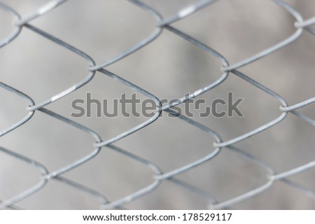 Old iron wire fence, close-up wire mesh fence blur background