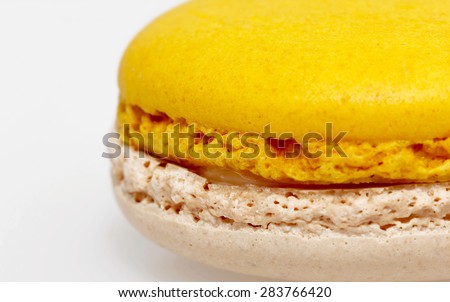 Yellow and white macaron on white background