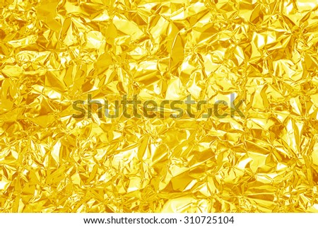 Gold  leaf  foil background with shiny crumpled uneven surface for texture background