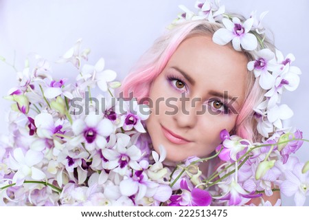 tender girl with pink hair in these orchids, close-up,Beautiful Fashionable Woman Posing Fashion portrait of a beautiful young blond woman.