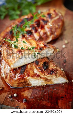 prepared on grill chicken fillet on cutting board with parsley