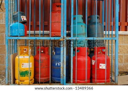Gas bottles stored in a cage. Waiting to be picked-up.