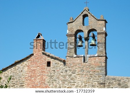 Middle-ages bell-tower on a stone house in Cortona (Tuscany), Italy. Typical architectural feature for Tuscany.