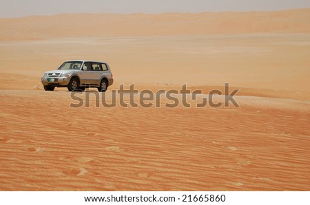 Off-road car in the middle of desert.