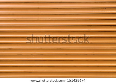 Orange, steel, shiny rolling shutter door texture with horizontal lines.