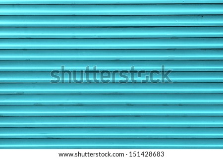 Blue, steel, shiny rolling shutter door texture with horizontal lines.