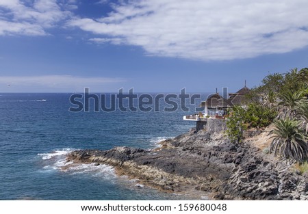 Coastal Landscape - Tenerife coast line and blue Atlantic Ocean with mountains in the background, Canary Islands, Spain.