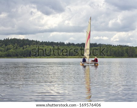 SUWALKI, POLAND - 15th of June 2011: Unknown people sailing on the Wigry lake on 15th of June 2011 in SUWALKI, POLAND