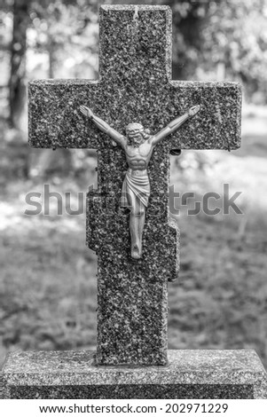 Old cross on one of the graves (black and white)