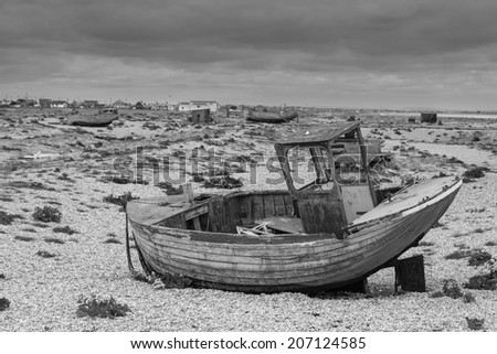 Vintage scene with old worn boat seen ashore (black and white)