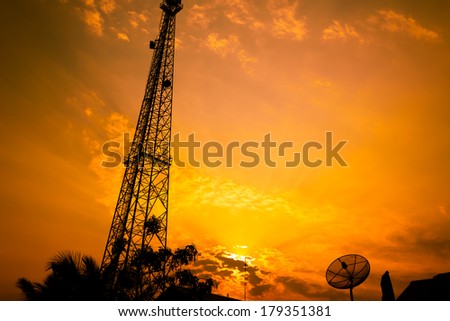 reception antenna and satellite dish with  orange sky