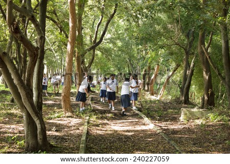 MAHASARAKHAM,THAILAND - SEPTEMBER 19 : Teachers and students together to clean the park on September 19,2014 in Mahasarakham,Thailand