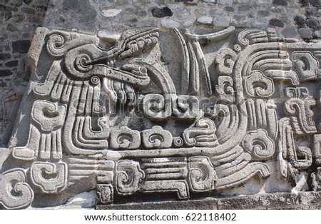 Barelief carving with of a Quetzalcoatl, pre-Columbian Maya civilization, Temple of the Feathered Serpent in Xochicalco, Mexico. UNESCO world heritage site