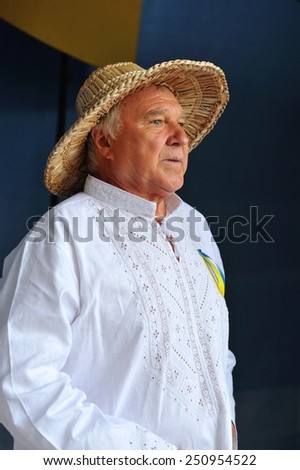 KIEV, UKRAINE - AUGUST 24: Old man in national clothes standing backstage and awaiting for his performance and it is seen that he is very excited - All Ukrainian Vyshyvanka Parade 2013, Ukraine.