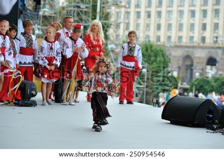 People in national clothes are awaiting for their performances and one little girl don\'t want to go away after her performance and keep dancing on the stage - All Ukrainian Vyshyvanka Parade, Kiev