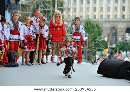 People in national clothes are awaiting for their performances and one little girl don\'t want to go away after her performance and keep dancing on the stage - All Ukrainian Vyshyvanka Parade, Kiev