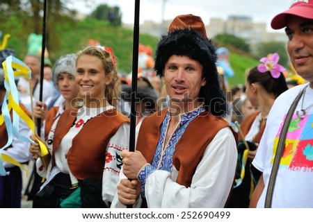 KIEV, UKRAINE - AUGUST 24: A racy man and a beautiful lady in embroided shirts and hoods at All Ukrainian Vyshyvanka Parade at Independence Day on August 24, 2013 in Kiev, Ukraine