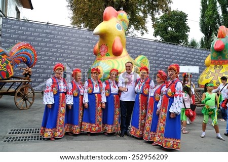 KIEV, UKRAINE - AUGUST 24: People making photos with a wonderwork-bird - a symbol and work of art each of the ukrainian regions specially made for All Ukrainian Vyshyvanka Parade at Independence Day