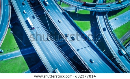 Aerial highway junction. Busy highway from aerial view. Highway shape like number 8 and infinity sign. Urban highway and lifestyle concept.