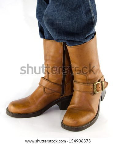 People wearing blue jeans, brown leather western cowboy  boots standing on white background.