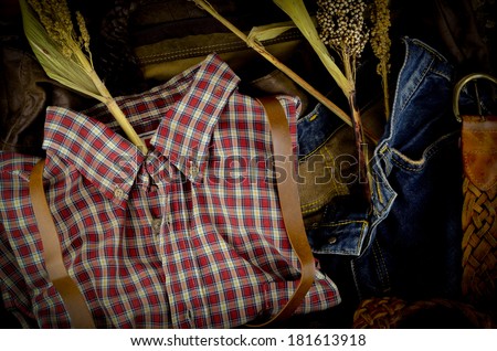 Cowboy style scottish striped shirt, hat, belt, brown leather ,still life and vintage style.